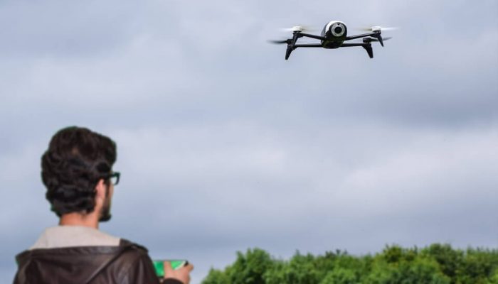 Young man holding a drone